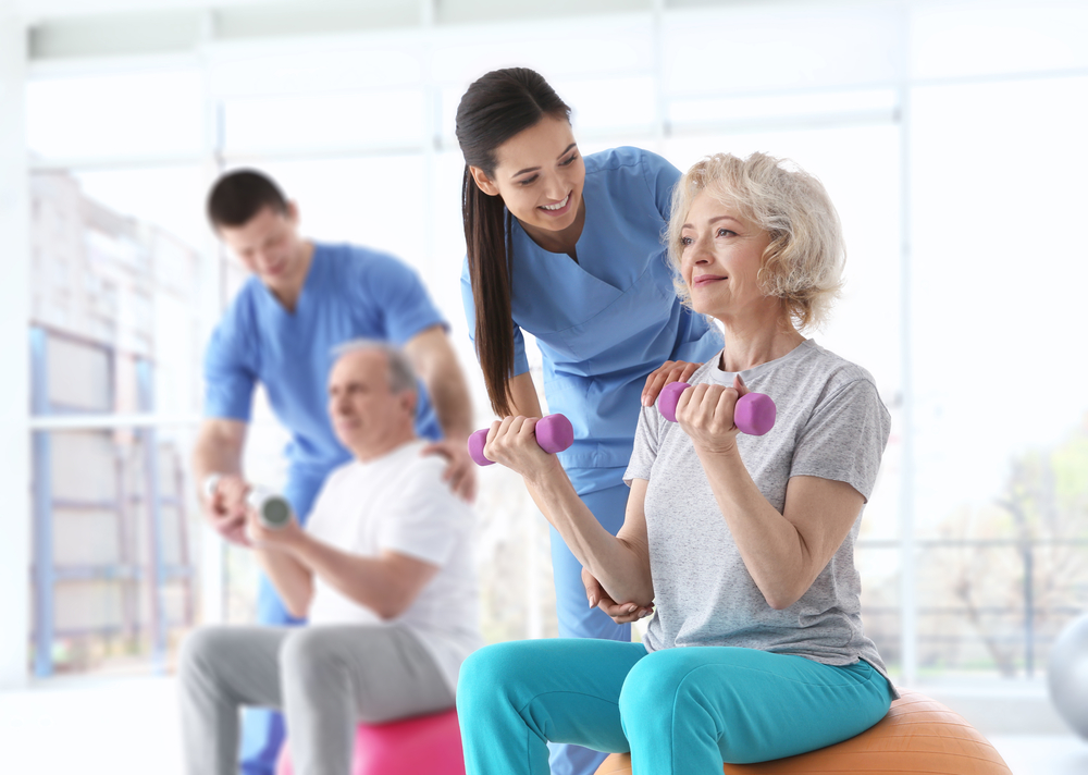 Physiotherapists,Working,With,Elderly,Patients,In,Modern,Clinic